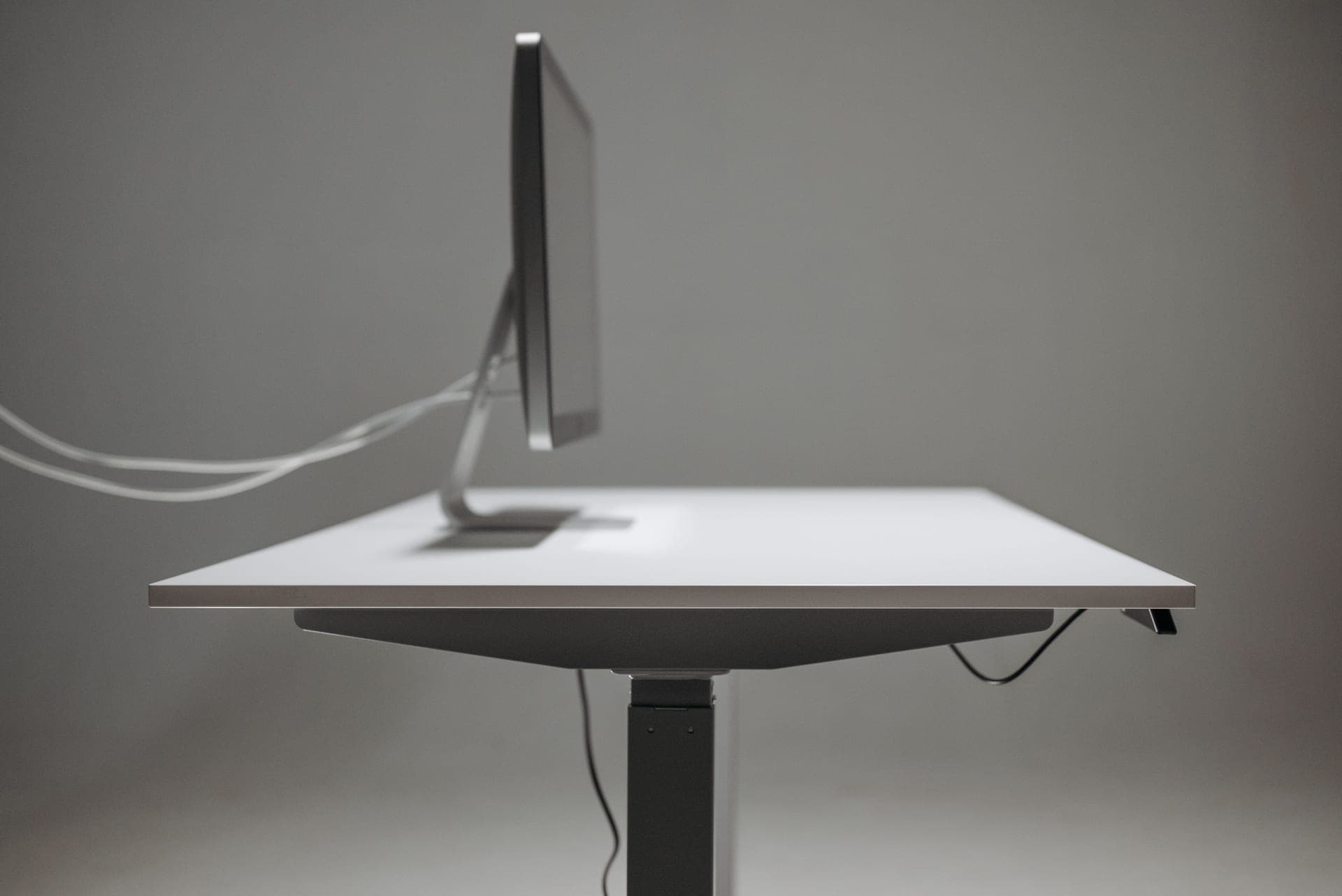 A clean sit-stand workstation with a height-adjustable desk
